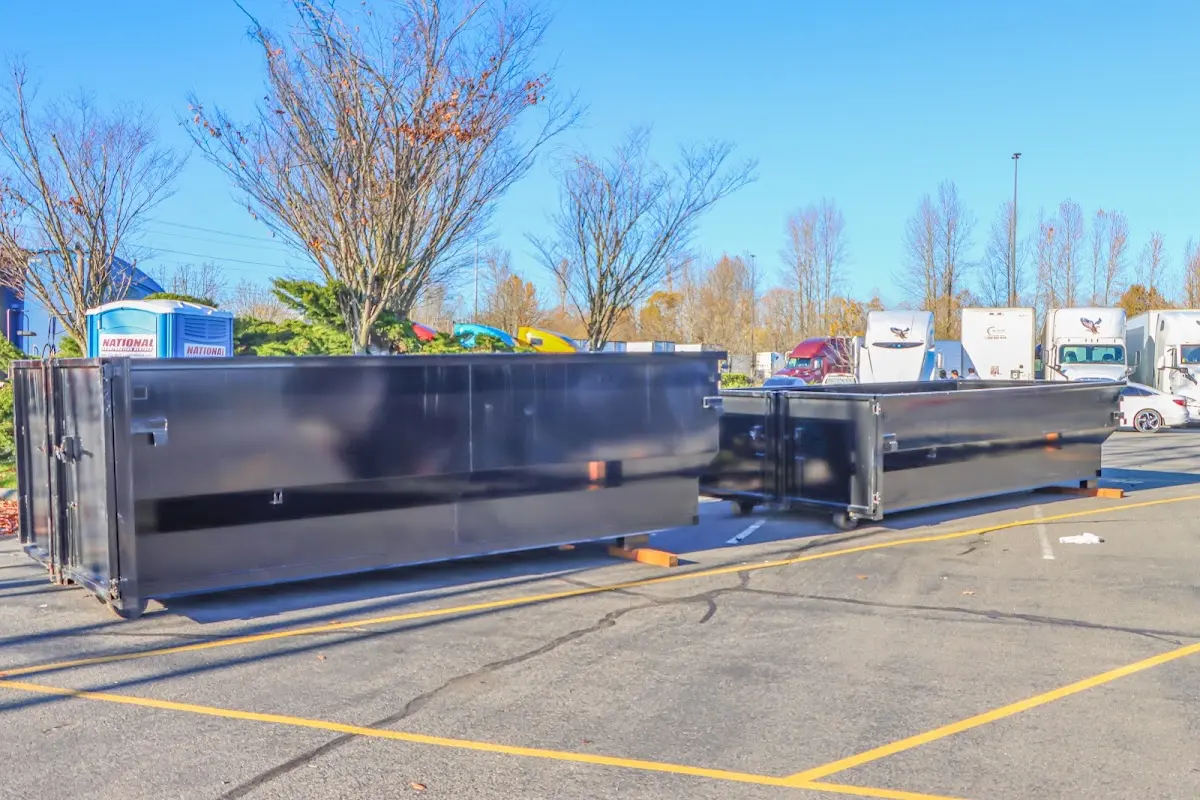 Professional dumpster rental service with roll-off container on residential driveway in Jeannette